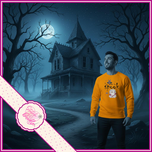 Man wearing an orange sweatshirt with a haunted house and moonlit scene